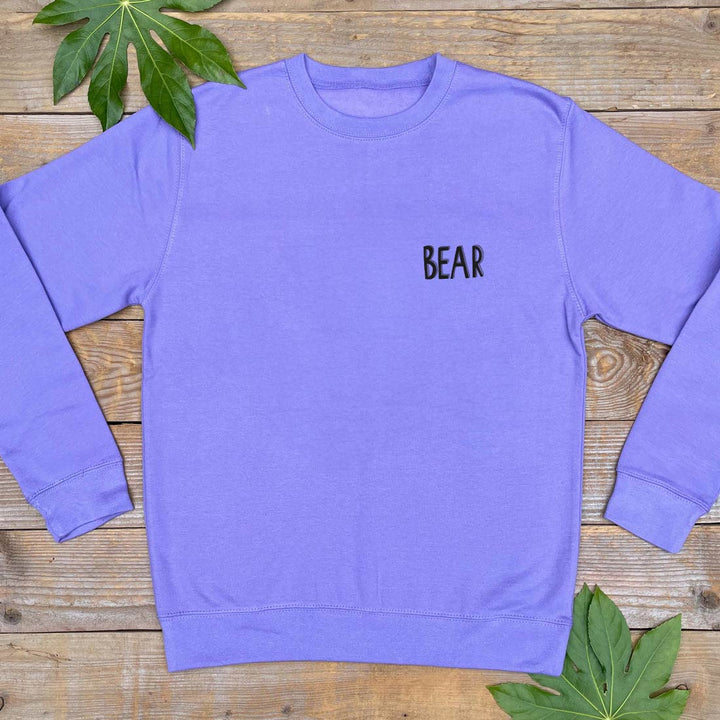 purple jumper with bear text