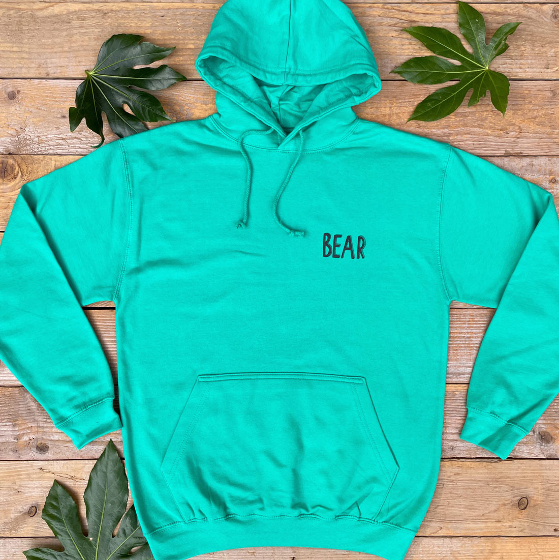 green hoodie with text bear print
