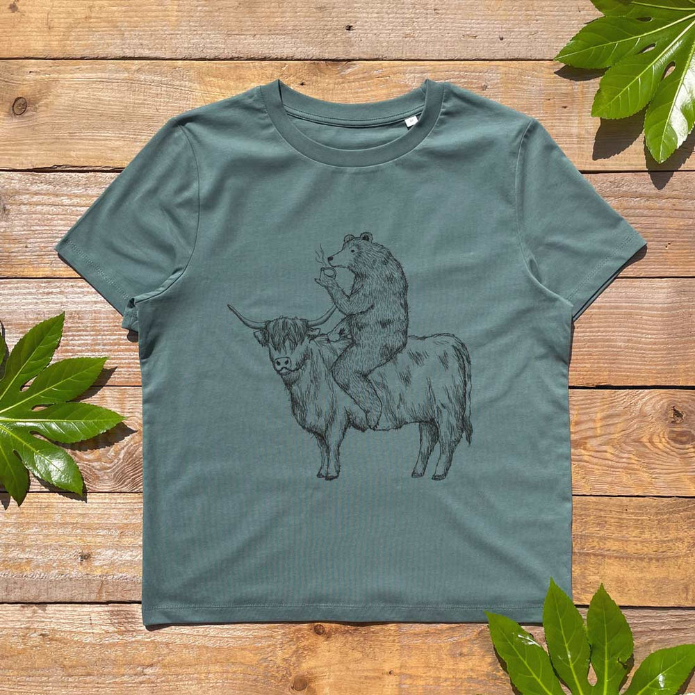 bear drinking tea riding a highland cow on a khaki tshirt