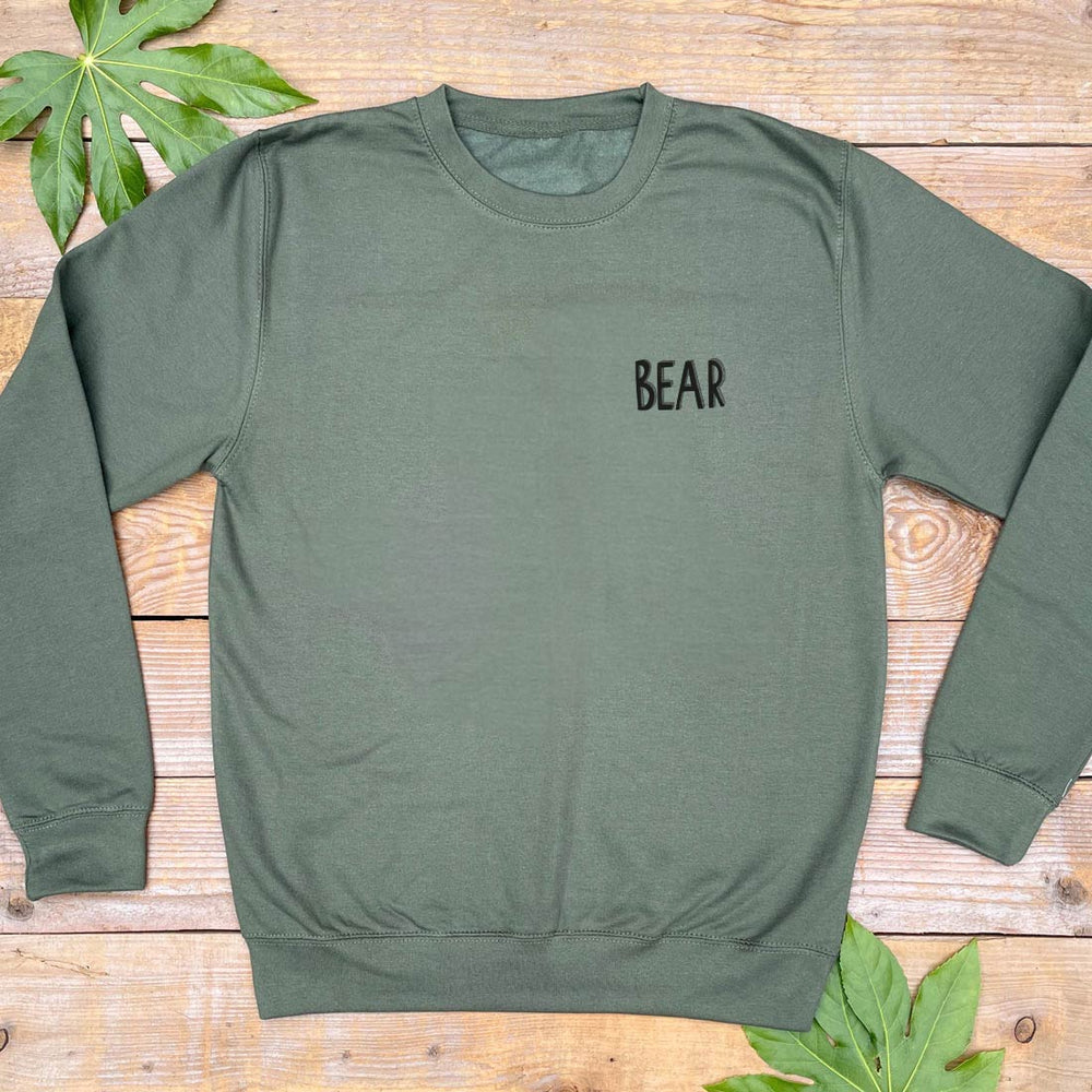 khaki jumper with bear text