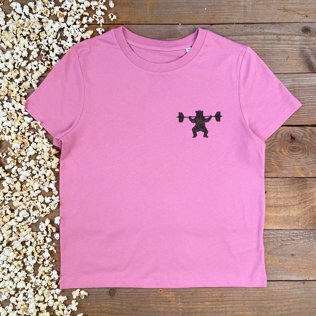 pink tee with weight lifting bear